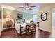 Sunlit bedroom boasts wood floors, and a quaint reading corner with a sewing machine at 8345 Moore St, Arvada, CO 80005