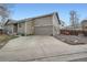 Charming home with a two car garage and a beautifully landscaped front yard at 8345 Moore St, Arvada, CO 80005