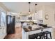Modern kitchen with white cabinets, stainless steel appliances, and barstool seating at 8345 Moore St, Arvada, CO 80005