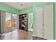Nicely painted bedroom with hardwood floors, a bookshelf, a nearby bathroom, a closet, and sliding glass doors at 3680 S Beeler St # 5, Denver, CO 80237