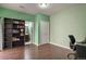 A nicely painted bedroom with hardwood floors, a bookshelf, a nearby bathroom, and a closet at 3680 S Beeler St # 5, Denver, CO 80237