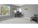 Bright bedroom featuring two windows, gray walls, neutral carpeting, and a desk and chair set up at 3680 S Beeler St # 5, Denver, CO 80237