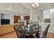 Open-concept living space featuring dining room with hardwood floors leading to the kitchen and living room at 3680 S Beeler St # 5, Denver, CO 80237