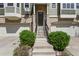 Front entrance featuring a set of stairs leading to a covered doorway flanked by green shrubbery at 3680 S Beeler St # 5, Denver, CO 80237