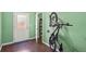 This entryway features hardwood floors, a bike on the wall, and a door leading to the exterior at 3680 S Beeler St # 5, Denver, CO 80237