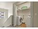 Brightly lit laundry room with newer washer and dryer units, plenty of storage above, and wood-look flooring at 3680 S Beeler St # 5, Denver, CO 80237