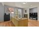 Cozy living room with a fireplace, hardwood floors, and sliding glass doors to the balcony at 3680 S Beeler St # 5, Denver, CO 80237