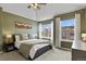 Stylish main bedroom with a tray ceiling, two large windows, and neutral decor providing a peaceful retreat at 3680 S Beeler St # 5, Denver, CO 80237