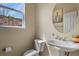 Charming powder room featuring a pedestal sink, round mirror, and window with neighborhood views at 3680 S Beeler St # 5, Denver, CO 80237