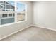 Bright room featuring neutral carpet, paint, and a large window at 383 Remuda Rd, Berthoud, CO 80513