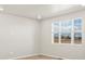 Bright bedroom featuring neutral walls, wood floors and a large window to filter in natural light at 383 Remuda Rd, Berthoud, CO 80513