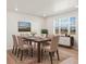 Bright dining room with a large window, wood table, seating for six, and a decorative rug at 383 Remuda Rd, Berthoud, CO 80513
