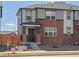 Inviting two-story townhome featuring brick and siding exterior, covered porch, and landscaped front yard at 383 Remuda Rd, Berthoud, CO 80513