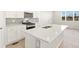 Bright kitchen featuring a stainless steel range, white cabinetry, gray backsplash and a sunlit breakfast nook at 383 Remuda Rd, Berthoud, CO 80513