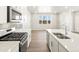Bright kitchen featuring an island with bar seating, stainless steel appliances, and modern finishes at 383 Remuda Rd, Berthoud, CO 80513