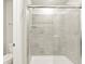 Sleek bathroom featuring a glass-enclosed shower with gray tiled walls at 383 Remuda Rd, Berthoud, CO 80513