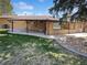 Backyard featuring a covered patio, well-maintained lawn, and a stone border at 4365 S Alton Way, Greenwood Village, CO 80111