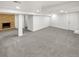 Spacious carpeted basement featuring a classic brick fireplace and neutral color palette at 4365 S Alton Way, Greenwood Village, CO 80111