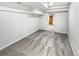 Finished basement space with neutral carpeting, white walls, and access to another room at 4365 S Alton Way, Greenwood Village, CO 80111