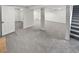 Finished basement offers a large open area and neutral carpet at 4365 S Alton Way, Greenwood Village, CO 80111