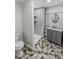 Modern bathroom featuring a patterned tile floor, stylish vanity, and walk-in shower with shelving at 4365 S Alton Way, Greenwood Village, CO 80111