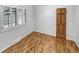 Bedroom with wood floors, a shuttered window and a wood door at 4365 S Alton Way, Greenwood Village, CO 80111