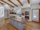 Gourmet kitchen features a large island with a cooktop, stainless steel appliances, custom cabinetry and granite countertops at 4365 S Alton Way, Greenwood Village, CO 80111