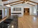 Spacious kitchen with island cooktop, breakfast bar, custom cabinets, granite countertops, and connection to the living area at 4365 S Alton Way, Greenwood Village, CO 80111