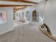 Bright living room with skylights, wooden beams, arched accents, and a unique brick fireplace at 4365 S Alton Way, Greenwood Village, CO 80111