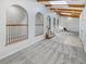 Spacious living room with neutral carpet, arched doorways, wooden beams, and bright skylights at 4365 S Alton Way, Greenwood Village, CO 80111