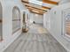 Open-concept living room with vaulted ceilings, wood beams, fireplace, and archways to different parts of the home at 4365 S Alton Way, Greenwood Village, CO 80111