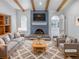 Inviting living room features a blue accent wall with brick fireplace and exposed beam ceiling at 4365 S Alton Way, Greenwood Village, CO 80111