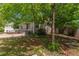 Landscaped backyard with lush lawn, mature trees, and privacy fence at 5403 Odessa St, Denver, CO 80249
