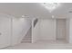 Finished basement offering a spacious living area with soft carpeting and stairway access at 5403 Odessa St, Denver, CO 80249