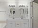 Bathroom featuring double sinks, a white vanity with shaker cabinets and two oval mirrors at 5403 Odessa St, Denver, CO 80249