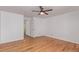 Bedroom with ceiling fan and hardwood floors, and doorway leading to an ensuite bathroom at 5403 Odessa St, Denver, CO 80249