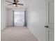 Cozy carpeted bedroom with natural light from the window and ceiling fan with light at 5403 Odessa St, Denver, CO 80249