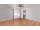 Spacious bedroom with ceiling fan, hardwood floors, sheer curtains and an ensuite bathroom at 5403 Odessa St, Denver, CO 80249