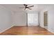 Spacious bedroom with ceiling fan, hardwood floors, sheer curtains and an ensuite bathroom at 5403 Odessa St, Denver, CO 80249