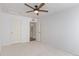Carpeted bedroom with ceiling fan, closet and attached bath at 5403 Odessa St, Denver, CO 80249