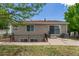 Exterior rear view of the home with a walk-out basement and sliding glass doors at 5403 Odessa St, Denver, CO 80249