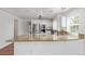 Bright kitchen with breakfast bar, stainless steel appliances, granite counters, and mosaic tile backsplash at 5403 Odessa St, Denver, CO 80249