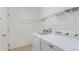 Bright laundry room with modern appliances and shelving for organized storage at 5403 Odessa St, Denver, CO 80249