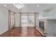 Open-concept living room featuring gleaming hardwood floors and a fireplace at 5403 Odessa St, Denver, CO 80249