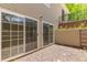 A walkout patio featuring sliding glass doors and a small gravel yard along the side of the home at 5403 Odessa St, Denver, CO 80249