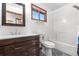 Well-lit bathroom features modern vanity, decorative tile flooring, and updated shower/tub combination at 25531 Mosier Cir, Conifer, CO 80433