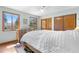 Bright bedroom with wooden dresser, natural light from windows, and closet for ample storage at 25531 Mosier Cir, Conifer, CO 80433