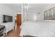 Bedroom featuring a bed, dresser with TV, and a view of another room at 25531 Mosier Cir, Conifer, CO 80433