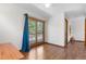 Well-lit room with hardwood floors and sliding glass doors opening to a scenic outdoor view at 25531 Mosier Cir, Conifer, CO 80433