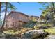 Exterior elevation featuring a multi-story home built into a mountainside at 25531 Mosier Cir, Conifer, CO 80433